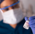 CRNA holding medication vial