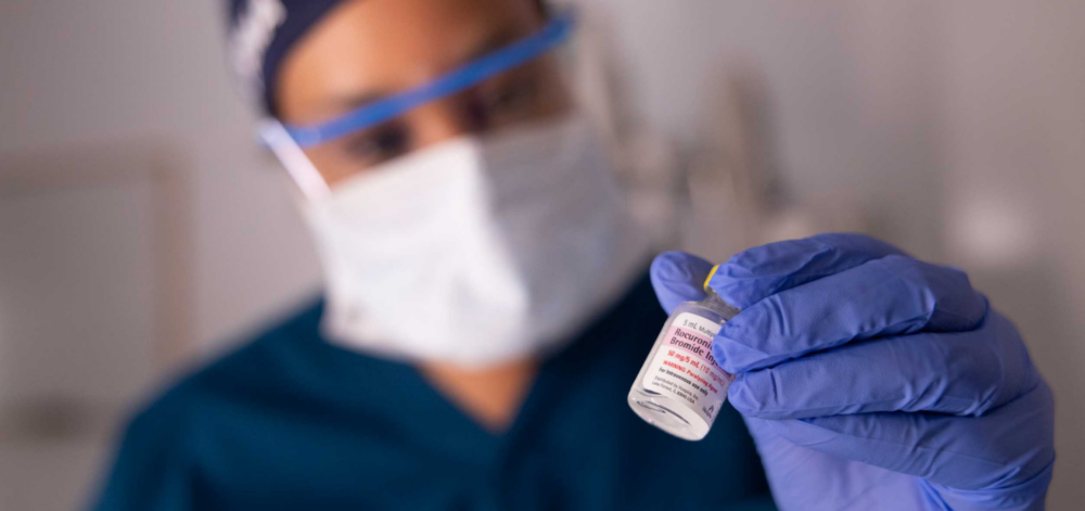 CRNA holding medication vial