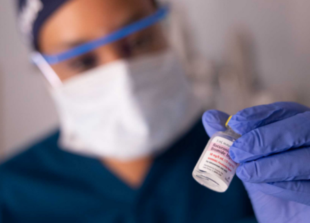 CRNA holding medication vial