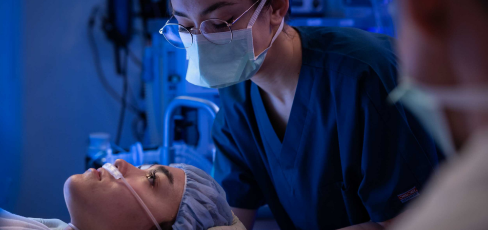 CRNA applying oxygen to female patient