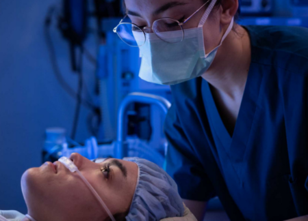 CRNA applying oxygen to female patient