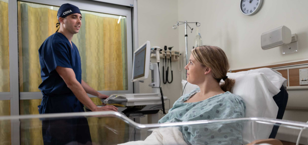 CRNA consulting with a patient