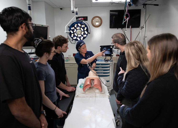 CRNA instructor with students in the OR