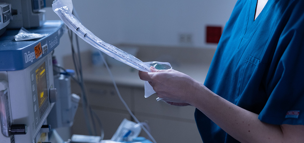 CRNA preparing anesthesia space for surgery.