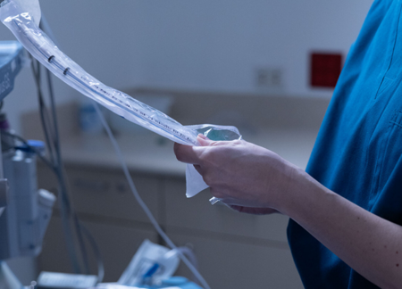CRNA preparing anesthesia space for surgery.