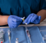 CRNA preparing medication for anesthesia in the operating room