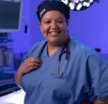 CRNA standing in the operating room smiling