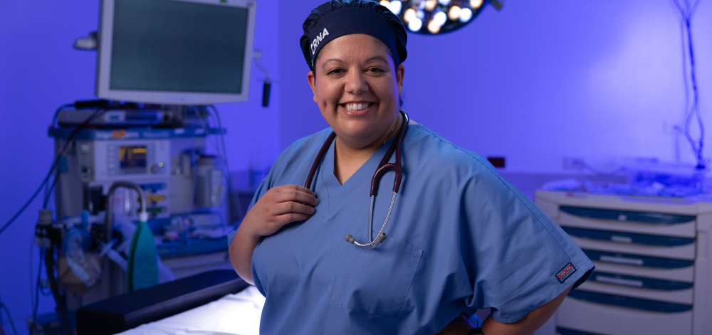 CRNA standing in the operating room smiling
