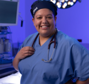 CRNA standing in the operating room smiling