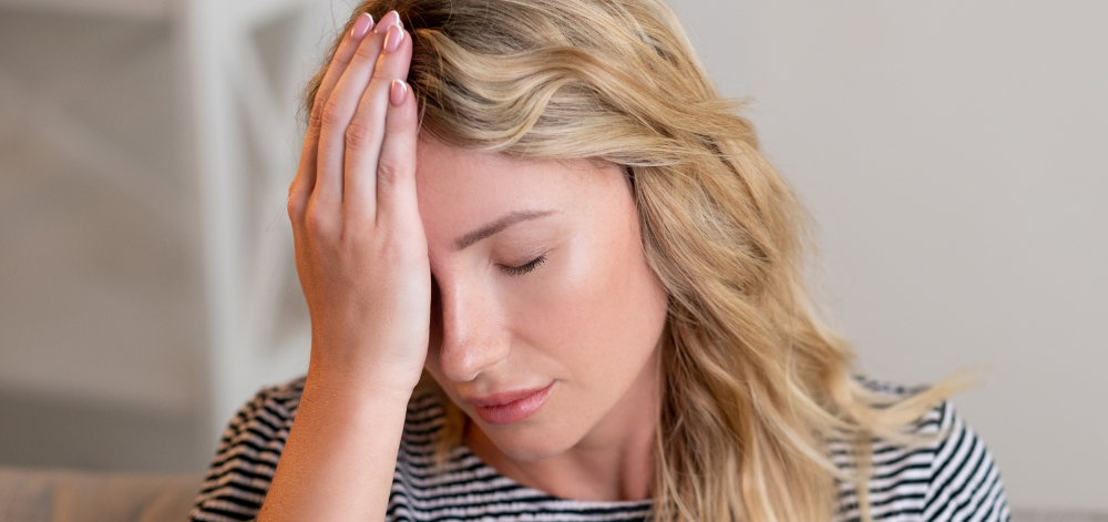 Woman with hand on her forehead