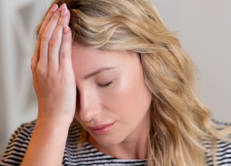 Woman with hand on her forehead