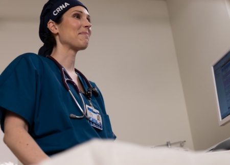 CRNA talking with a patient in bed
