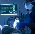 CRNA administering anesthesia in an OR with an assistant