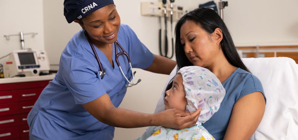 Parent with child and CRNA before surgery