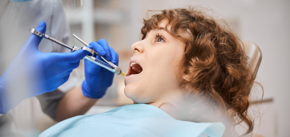 Child being given anesthesia at the dentist