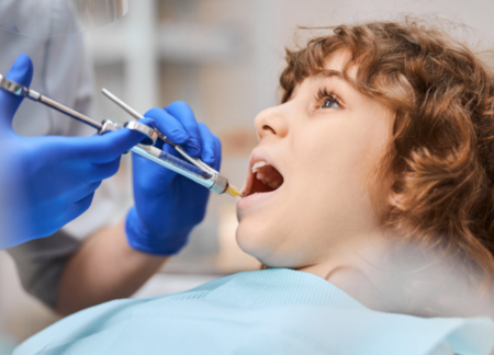 Child being given anesthesia at the dentist