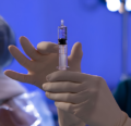 CRNA prepping syringe in OR