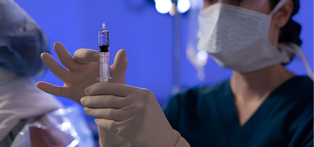 CRNA prepping syringe in OR
