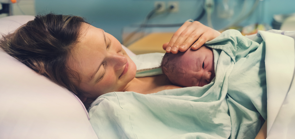 Woman with newborn on chest