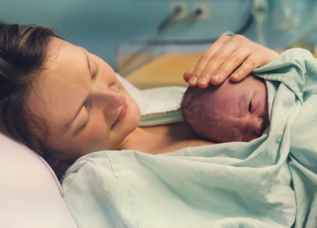Woman with newborn on chest