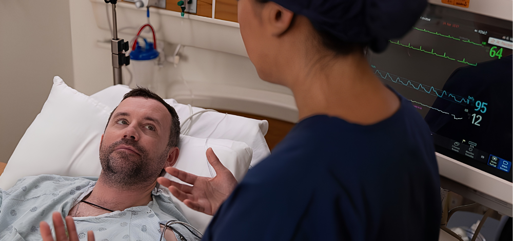 CRNA speaking to man at bedside