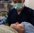 Older man on OR table with CRNA