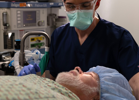 Older man on OR table with CRNA