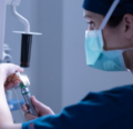 CRNA preparing to administer anesthesia to patient