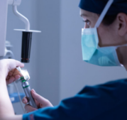 CRNA preparing to administer anesthesia to patient