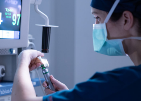 CRNA preparing to administer anesthesia to patient